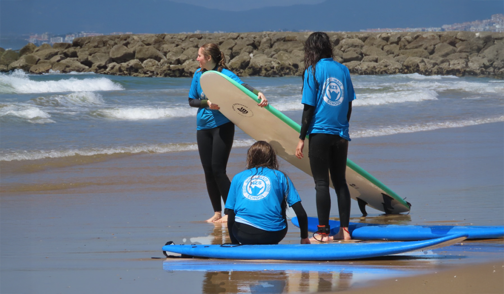kids with surfboards at the beach
